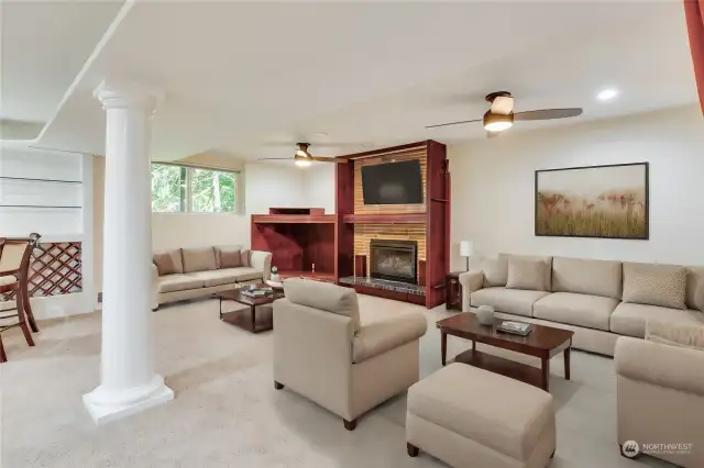 Downstairs living area with gas fireplace and bar / kitchenette area.