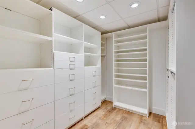 Downstairs walk-in closet with custom closet organization system.