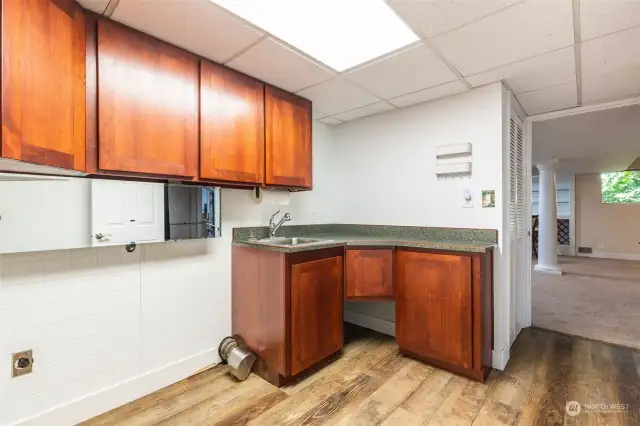 Laundry room downstairs with sink.