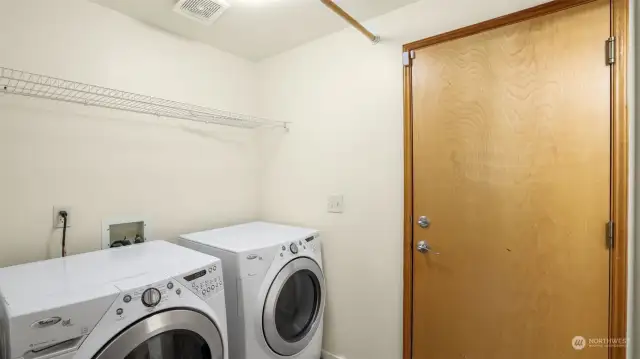 Washer and dryer stay.  This door leads to the garage.