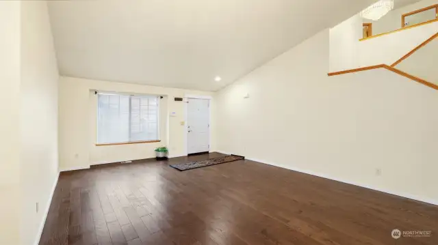 Looking from the dining area toward the front door.  On the right are the stairs.