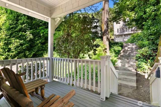 Enjoy a morning coffee or evening unwind from your covered front porch, surrounded by mature greenery and set back from the street for extra privacy and charm.