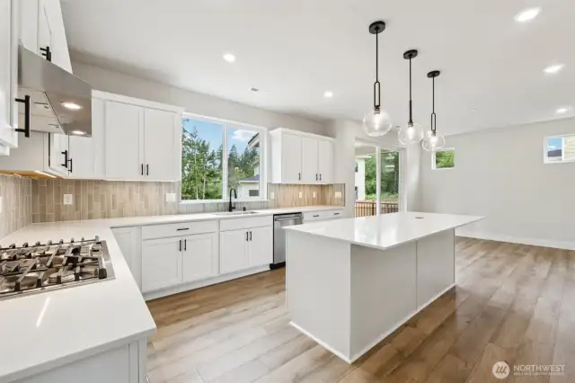Beautiful!  Large windows, 9' ceilings throughout, qtz counters, black hardward w/soft cabs.  Upgraded spring faucet. Cafe' GE Appliances, gas stove PLUS the Refrigerator is included on this home.