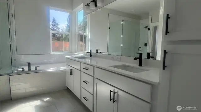 Hotel-Style primary bath includes 12x24 tile floors, quartz counters, black hardware, plumbing and lighting.  Soft close cabinets and drawers.  Huge soaking tub and frameless tiled walk-in shower.  A dream walki-n closet and separate water closet for privacy.
