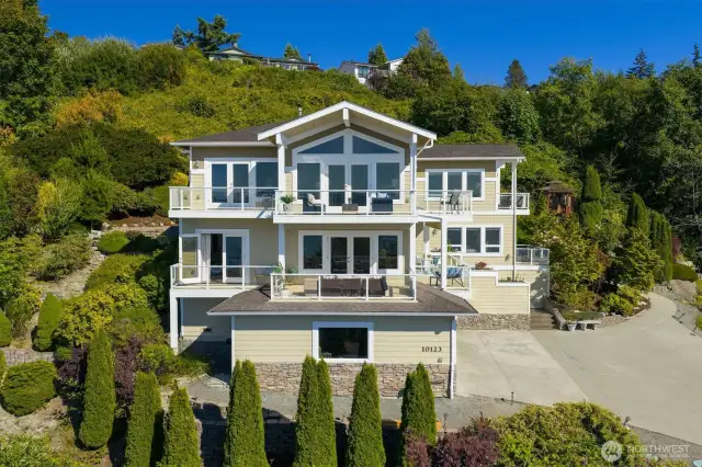 Perched high and proud, this NW-inspired home is located in the desirable Chennault Beach neighborhood