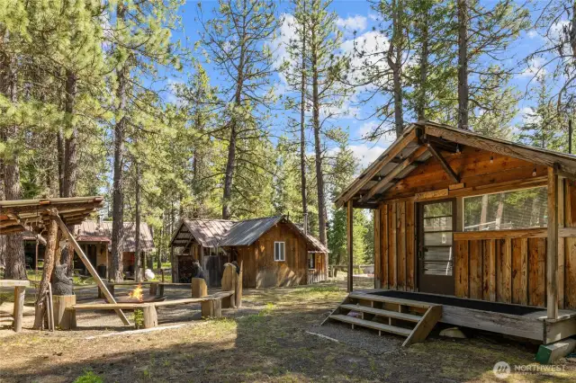 Studio cabin & main cabin with the firepit in the middle!