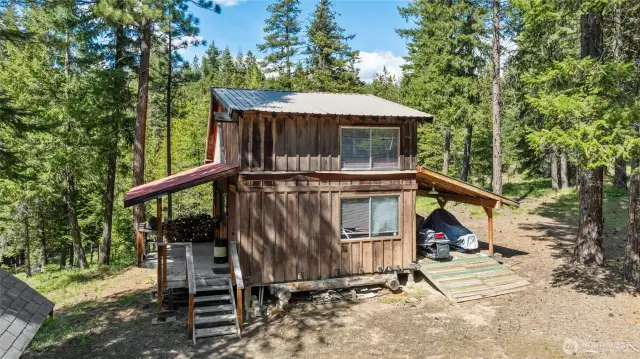 Pool Hall exterior- you can see the great front porch here as well as the lean to covered parking for 4 snowmobiles.