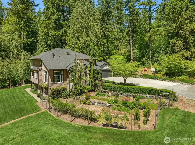 Beautiful gardens with berries and fruit trees throughout the property.