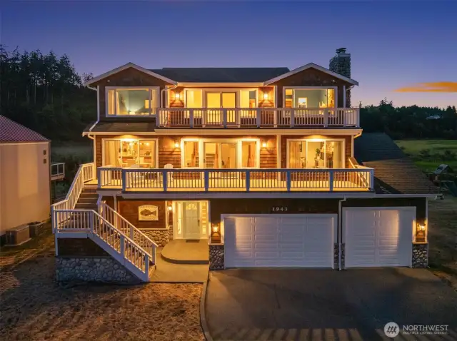 Shore Ave view of multi level home with Shingle siding and river rock accents. 2+ car garage plus boat/RV garage.
