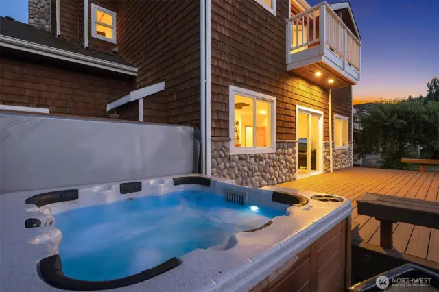 Back deck off of recreation room with hot tub.