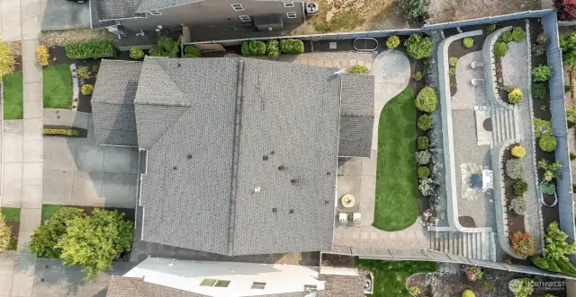 Extensive tiered backyard with retaining walls, raised garden bed & upper-level seating