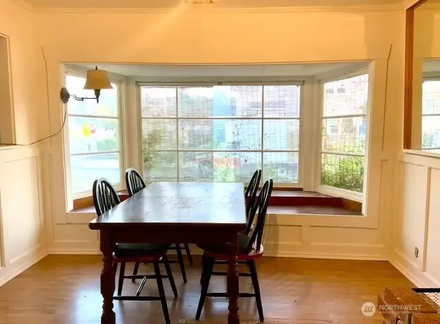 Lovely bright dining room with wainscotting and big bay window seat make this a wonderful place to gather and entertain!