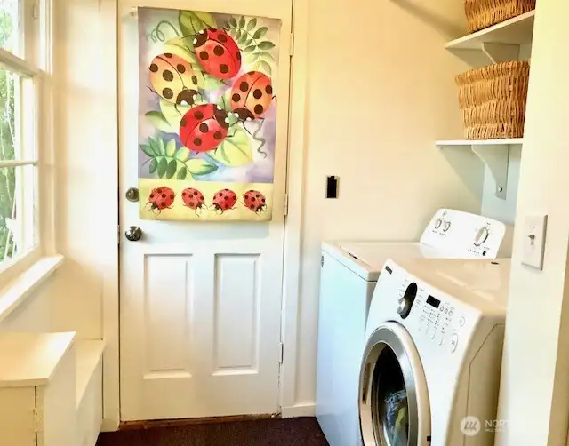 Utility room conveniently located next to kitchen, window for natural light and fresh air and back door to covered porch.