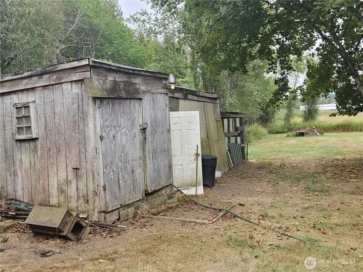 Well storage shed with 1000 gal holding tank  .Chicken Coop on the end with chickens if you would like them!