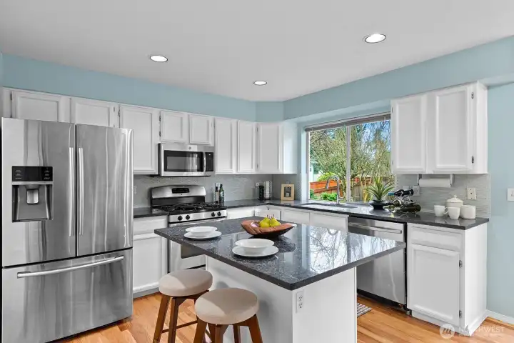 Kitchen with granite counters and stainless steel appliances.