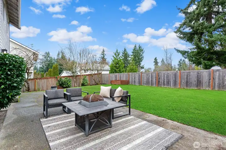 Large patio in the level rear yard.
