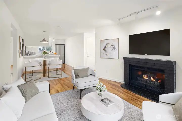 The living room is large enough for sofa, chairs and accent table.  Virtual staging.