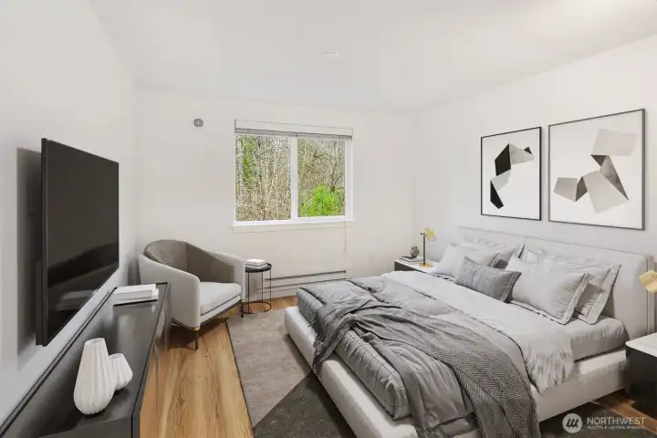 One of two bedrooms is large enough for a queen sized bed, access chair, side tables and dresser.