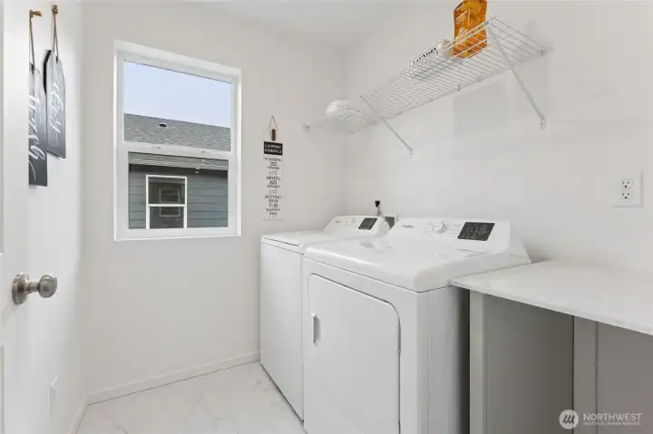 Upstairs laundry room with a folding table. Pictures are for representational purposes only, colors and features may vary. Upstairs laundry room with a folding table. Pictures are for representational purposes only, colors and features may vary.