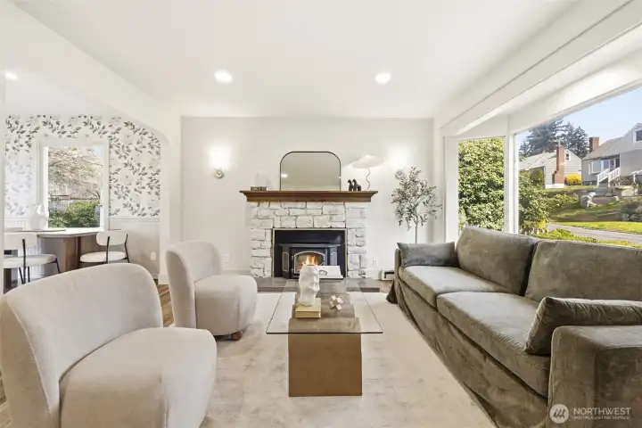 Large windows, warm tones, and a statement fireplace