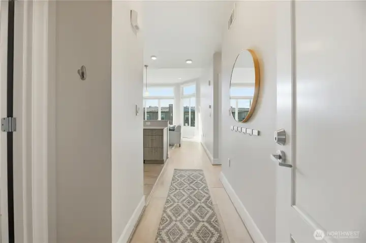 This welcoming entry leads you into the light-filled and warm open living space.