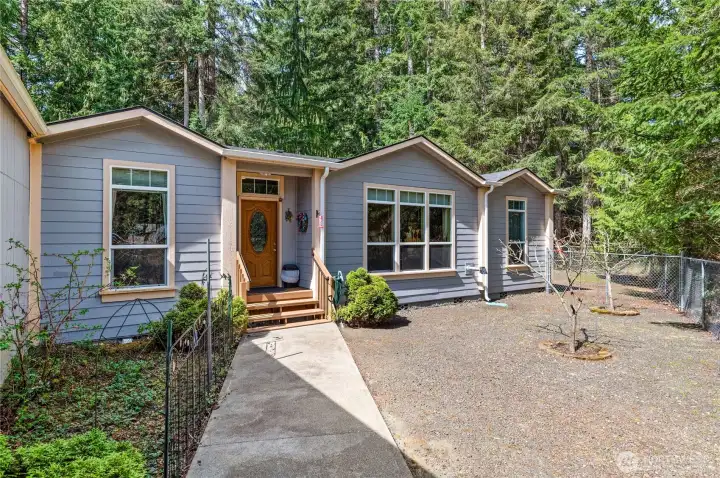 Front Door entrace go thru chain link fence Rt side of driveway .