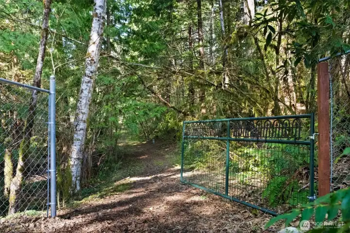 Back yard gate the trail leads to more acreage and creek view