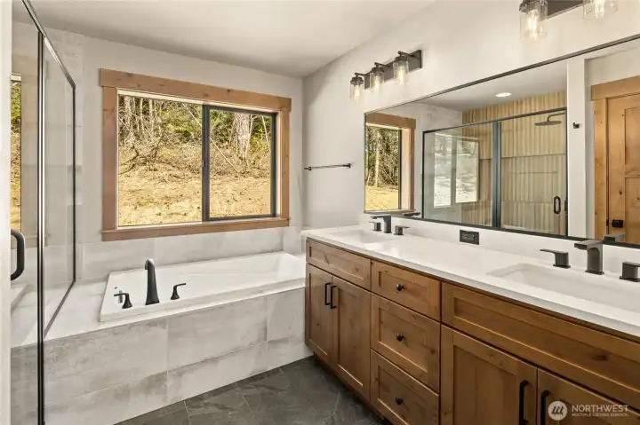 Double sink vanity with quartz countertop and slate floor. Master bedroom full bath