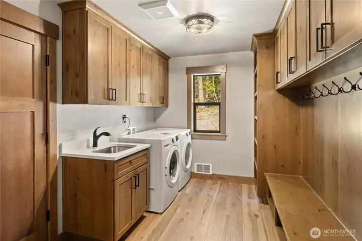 Laundry room with generous storage. Door leads to garage.