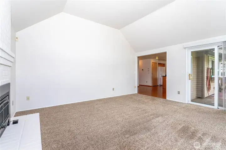Large vaulted ceiling adjacent to the kitchen, with slider to rear patio & garden