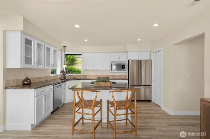 Spacious kitchen featuring a large walk in pantry on the right of the fridge.