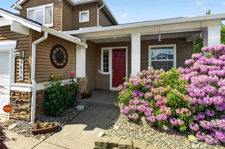 Covered front porch area with sunshades and room for seating