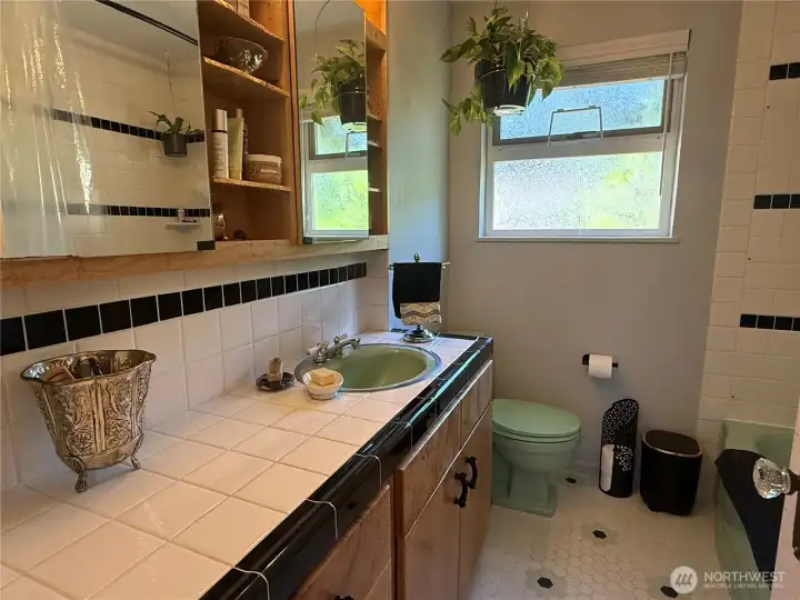 Main bathroom has original cast iron tub, sink & toilet. Cabinetry is solid maple and upper cabinet is extra deep. Main bathroom has original cast iron tub, sink & toilet. Cabinetry is solid maple and upper cabinet is extra deep.