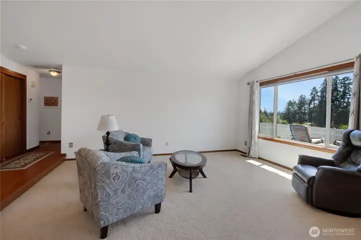 Sunken formal living room with vaulted cieling and picture windows to enjoy the view.