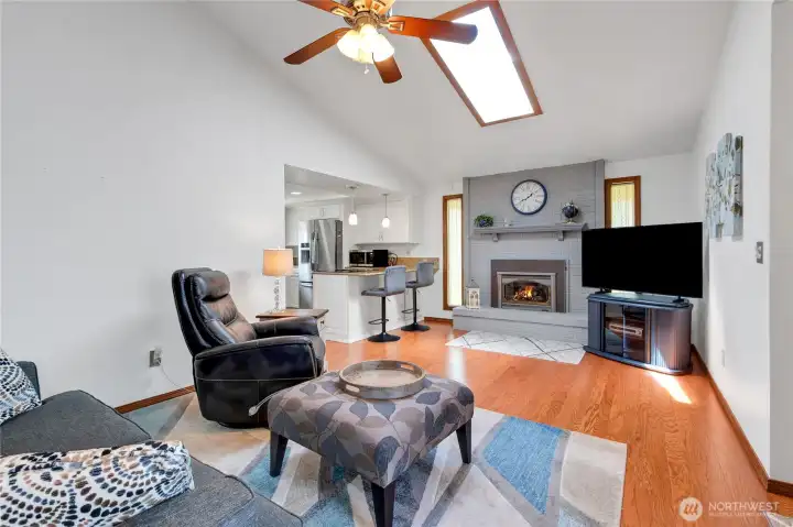 Family room with cieling fan and ffireplace insert.
