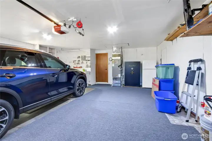 Garage is spacious and offers work bench space.