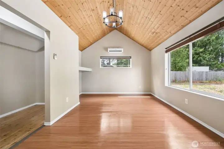 Bedroom on main floor looks out to the backyard. (floor was freshly mopped just prior to photos so appears wet).   Notice the dual split system in the bedroom.