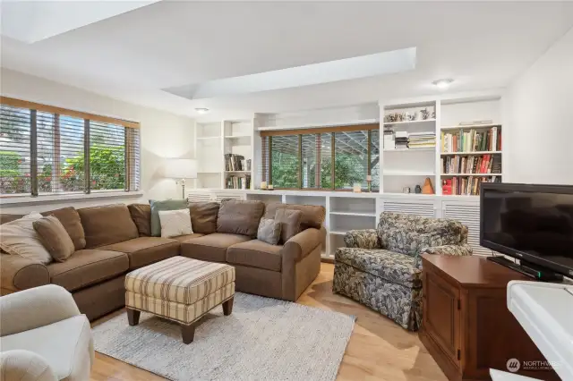 Spacious rec room with built-in cabinets, fireplace and skylights for abundant natural light.