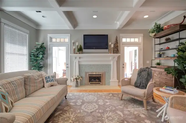 The main living space is perfect to cozy up by the fireplace.  Behind the fireplace is a finished sunroom perfect space for reading and playing games. The high ceilings and transom windows allow this room to fill with natural light.