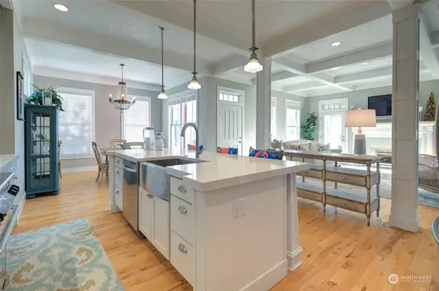 One the other side of the entry is an open kitchen and dining room.  The large island is placed so the chef and dishwasher can be a part of the gathering and not miss a thing.