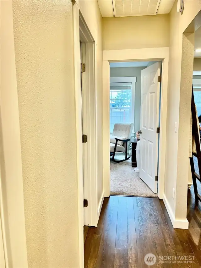 Hallway leading to bedrooms on each side, with a full bathroom conveniently located in the middle for easy access.