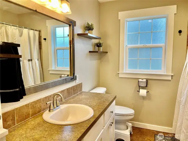 Full bathroom with natural tones and a stylish tile backsplash, creating a warm and inviting atmosphere.