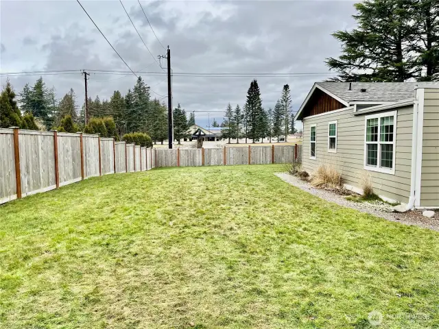 Fully fenced side yard, offering privacy and a secure space for outdoor activities or pets.