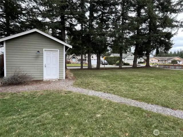 One-car garage with a garage door on one side and a convenient door on the other, offering easy access and versatility for storage or projects.