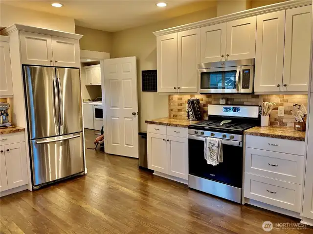 Spacious kitchen with plenty of cabinets, offering ample storage and an open layout