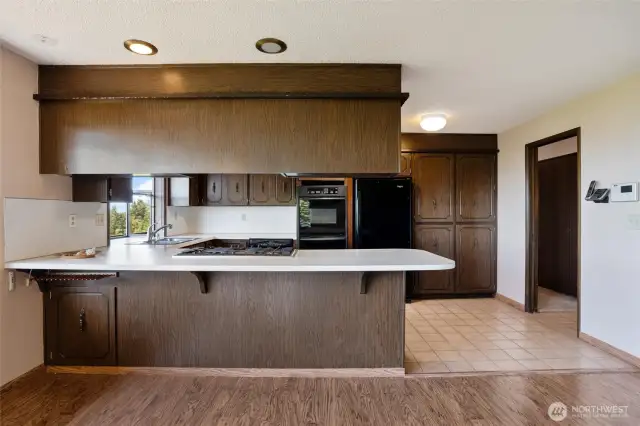 The kitchen has an eating bar for additional seating.