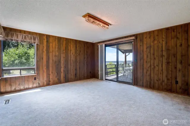 A room off of the entryway could be used as a living room or game room.  A deck is accessed from this room and  also from the dining room/main living space.