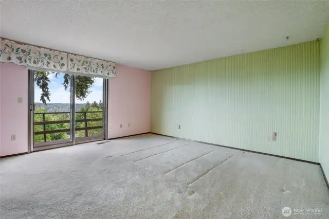The primary bedroom is quite large and enjoys access to the deck on the front side of the home. Wake up to views of the Olympics and Henderson Bay daily.