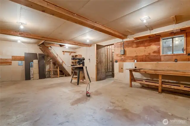 A storage area is located up the stairs as well.  Built-in workbenches are a part of this work space.