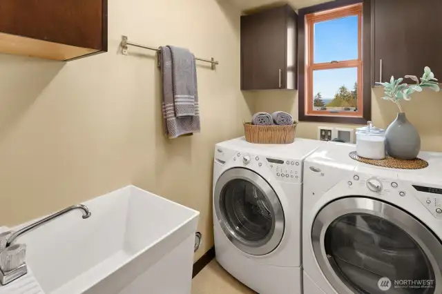 Lower floor laundry room with front loading W/D and deep sink